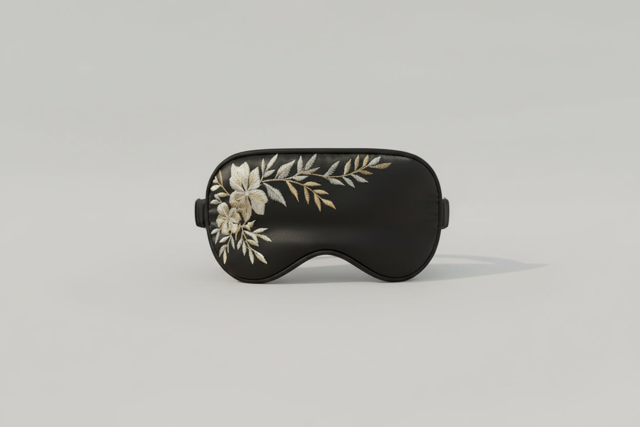 Chamomile aromatherapy sleep mask in black fabric on neutral background
